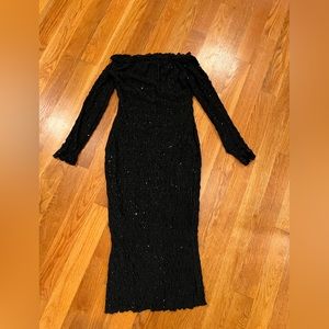 Off shoulder fitted black and gold glitter dress